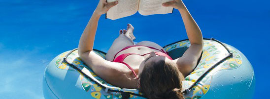 woman reading book in swimmingpool